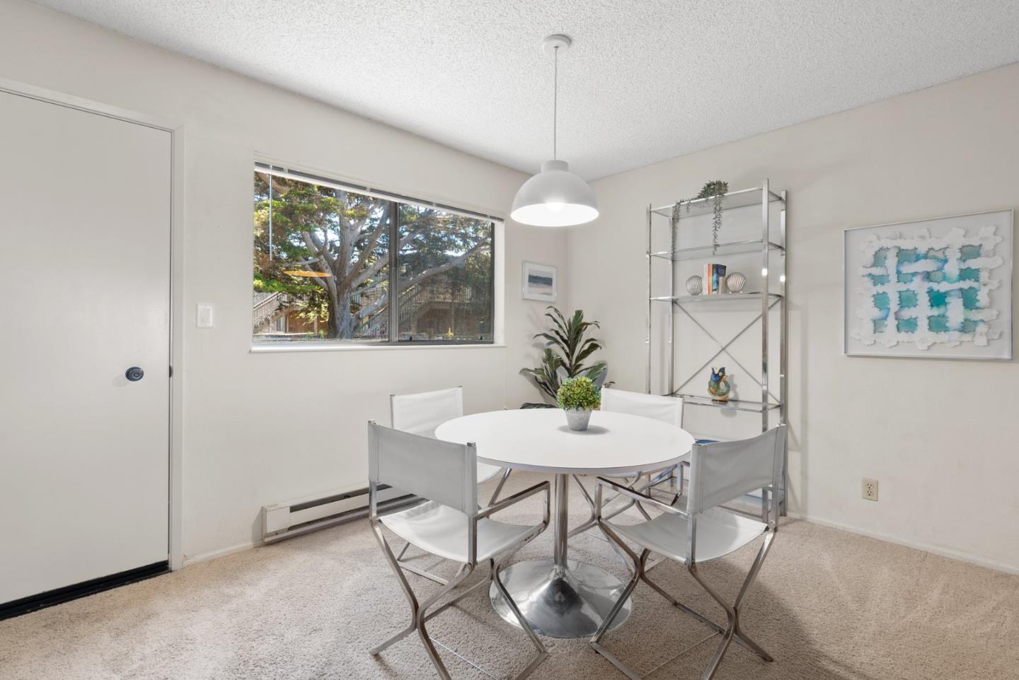 101 Shell Road, Unit 227 Watsonville, CA 95076 - Photo 11 of 29 a view of a dining room with furniture a chandelier and wooden floor