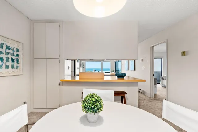 a living room with stainless steel appliances kitchen island granite countertop furniture and a fireplace