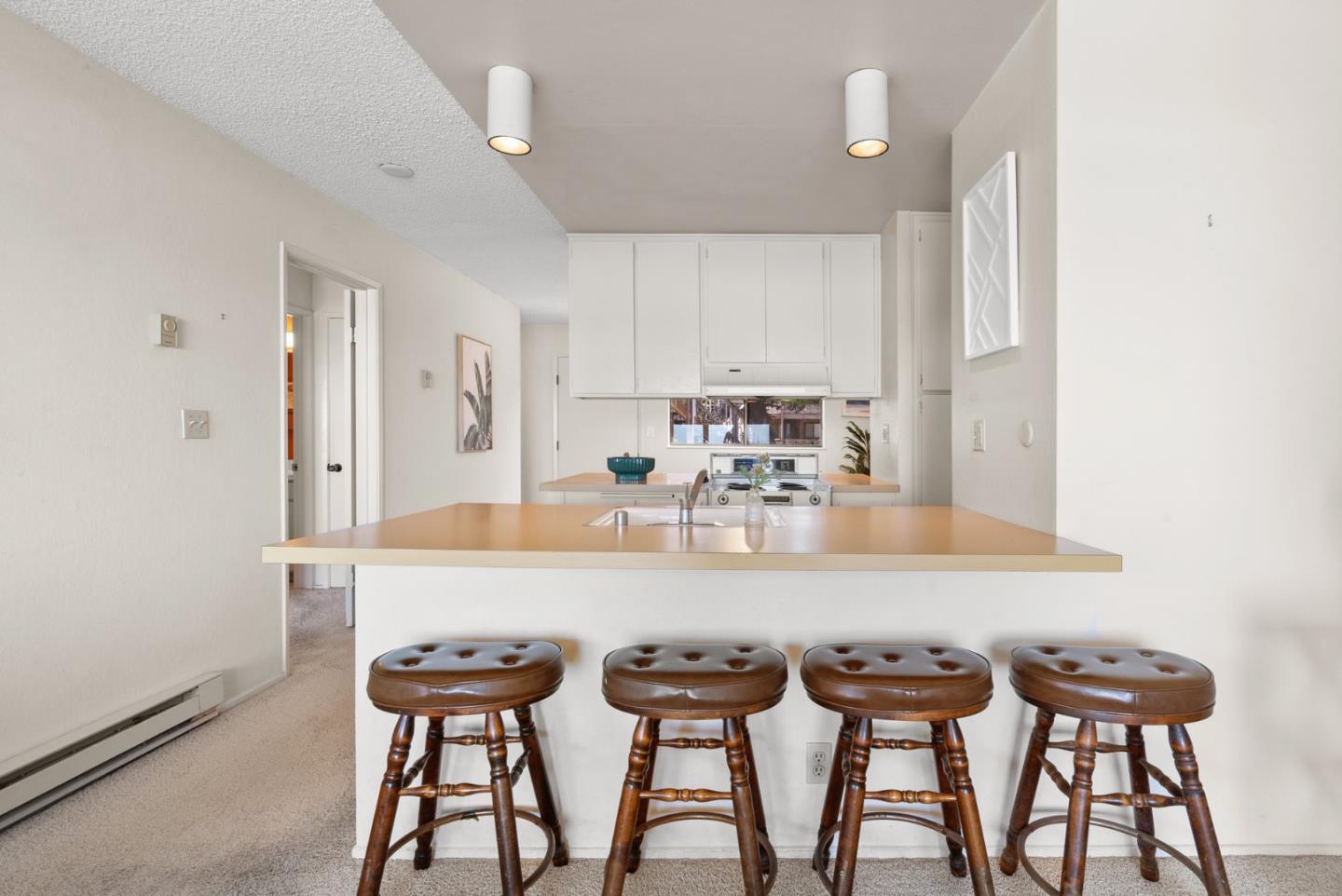 101 Shell Road, Unit 227 Watsonville, CA 95076 - Photo 15 of 29 a kitchen with granite countertop a table chairs stove and cabinets