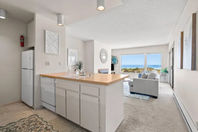 a spacious en suite bathroom with a double vanity sink a mirror and a bathtub