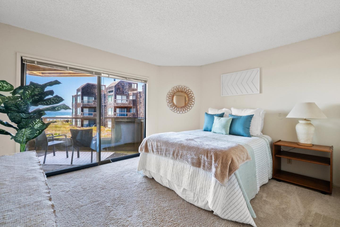 101 Shell Road, Unit 227 Watsonville, CA 95076 - Photo 25 of 29 a spacious bedroom with a bed a table and potted plant on table