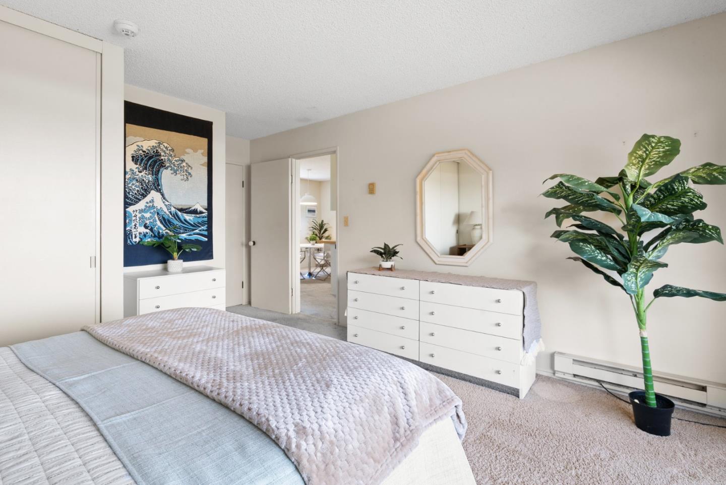 101 Shell Road, Unit 227 Watsonville, CA 95076 - Photo 27 of 29 a bedroom with a bed potted plant and a window