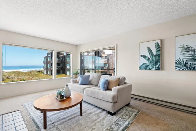 a living room with furniture and a potted plant