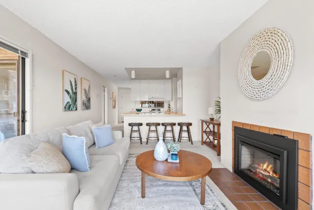 a living room with furniture a rug and a fireplace