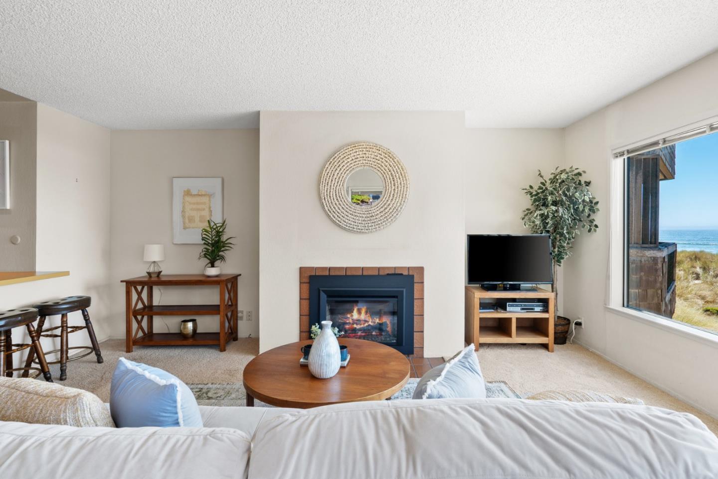 101 Shell Road, Unit 227 Watsonville, CA 95076 - Photo 9 of 29 a living room with furniture a fireplace and a flat screen tv