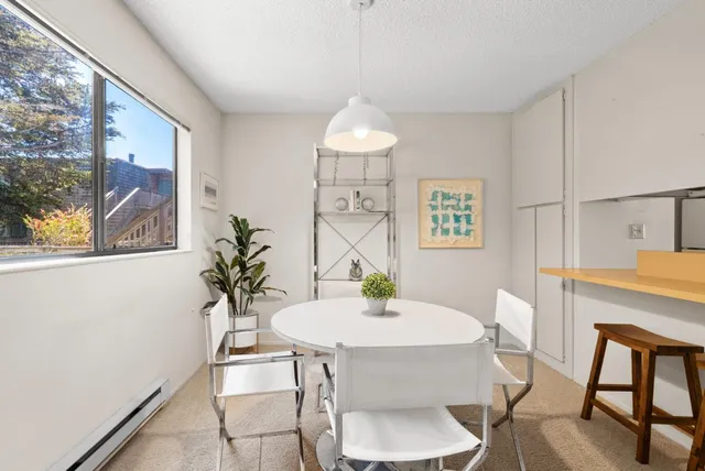 a dining room with furniture a rug and wooden floor