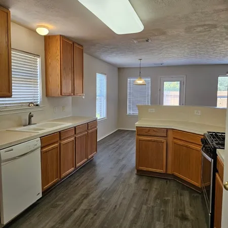 a kitchen with granite countertop a stove and a sink