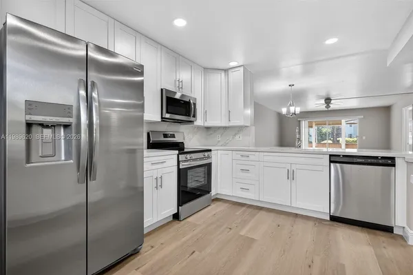 a kitchen with a refrigerator stove and microwave