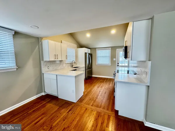 a view of kitchen with cabinets and wooden floor
