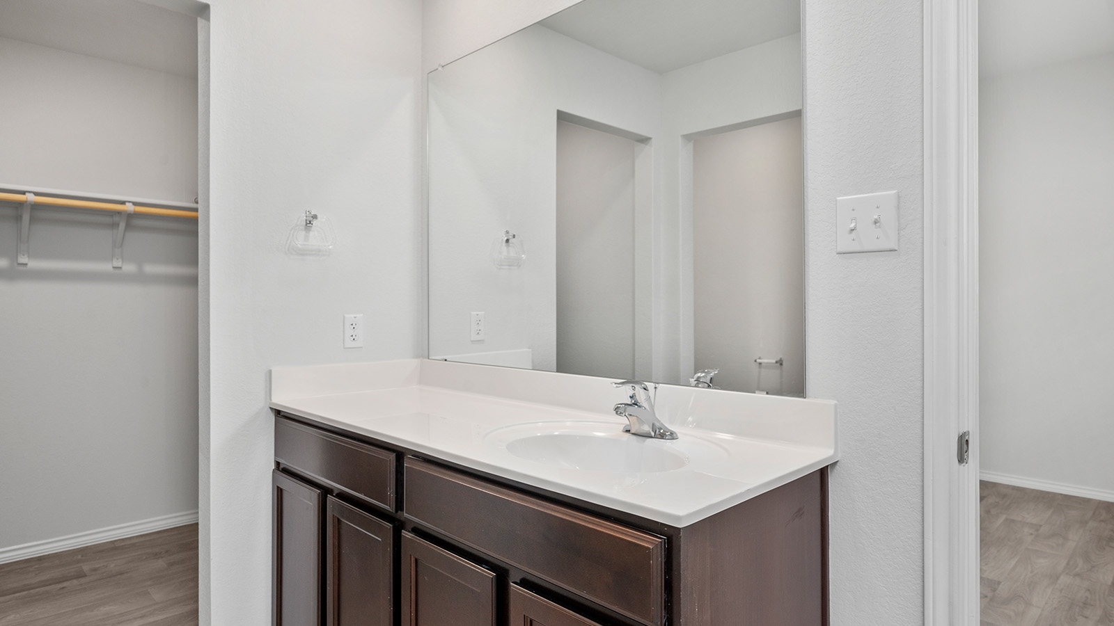 1418 Victory Rnch Trail Killeen, TX 76549 - Photo 12 of 22 A well-appointed bathroom vanity with a spacious countertop and integrated sink, accompanied by a nearby walk-in closet.