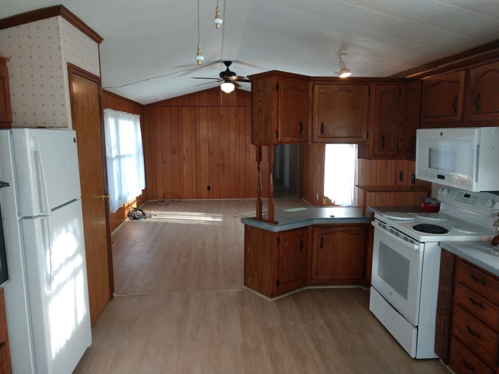 414 Palmer Road Ware, MA 01082 - Photo 8 of 16 a kitchen with stainless steel appliances granite countertop a stove a refrigerator and a sink with wooden cabinets