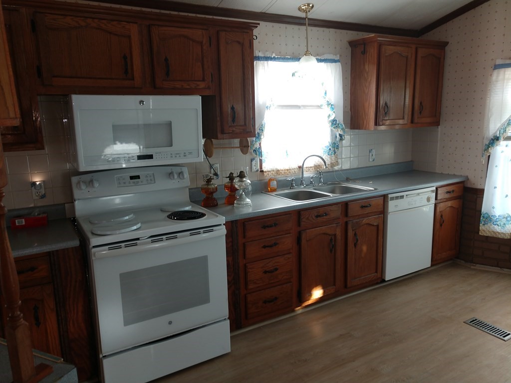 414 Palmer Road Ware, MA 01082 - Photo 9 of 16 a kitchen with a stove sink and cabinets