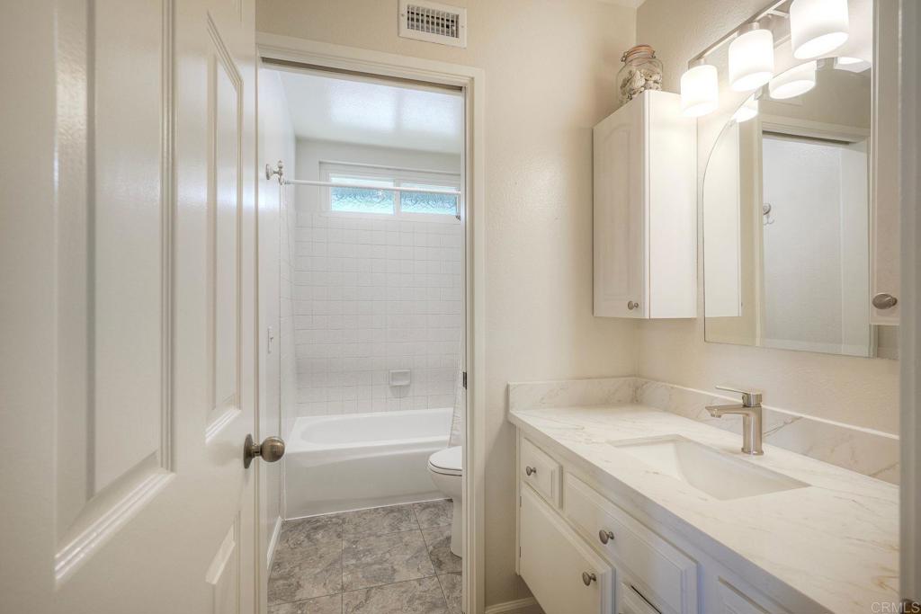 13639 Freeport Road San Diego, CA 92129 - Photo 19 of 44 a bathroom with a granite countertop sink toilet and shower
