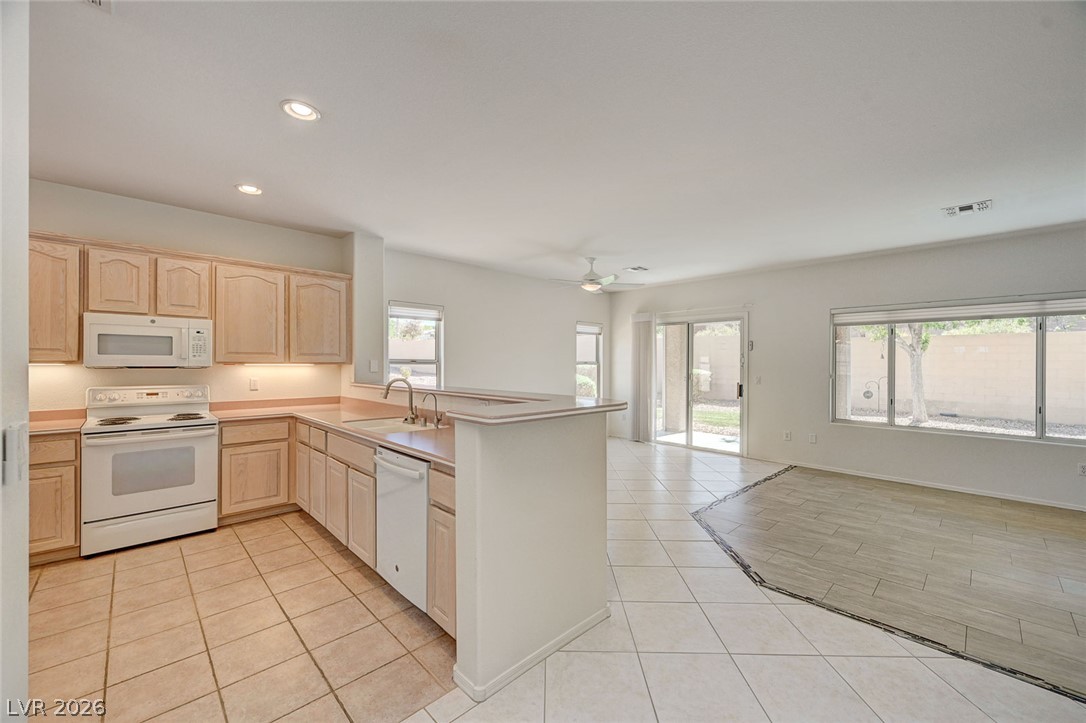 2529 Springville Way Henderson, NV 89052 - Photo 70 of 70 An open floor plan seamlessly connects the kitchen to a spacious dining or living area.