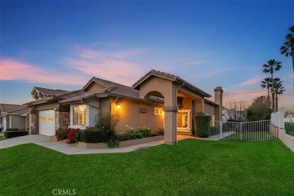 a front view of a house with a yard and pathway