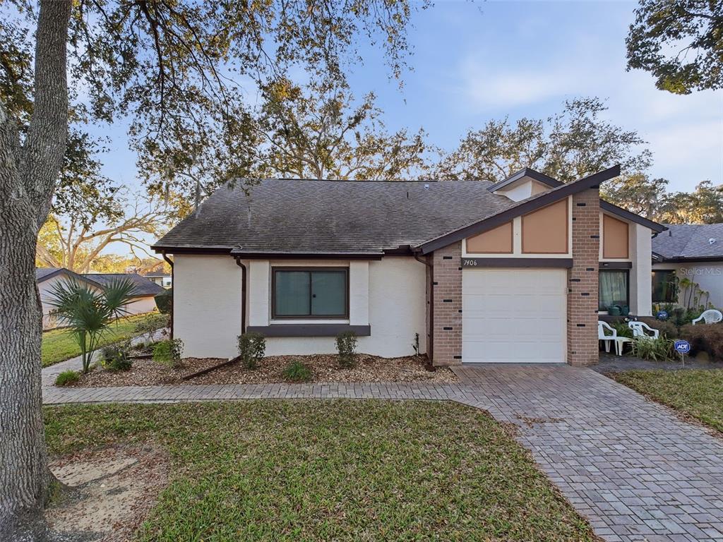 7406 Heather Walk Drive Weeki Wachee, FL 34613 - Photo 12 of 49 a front view of a house with garden