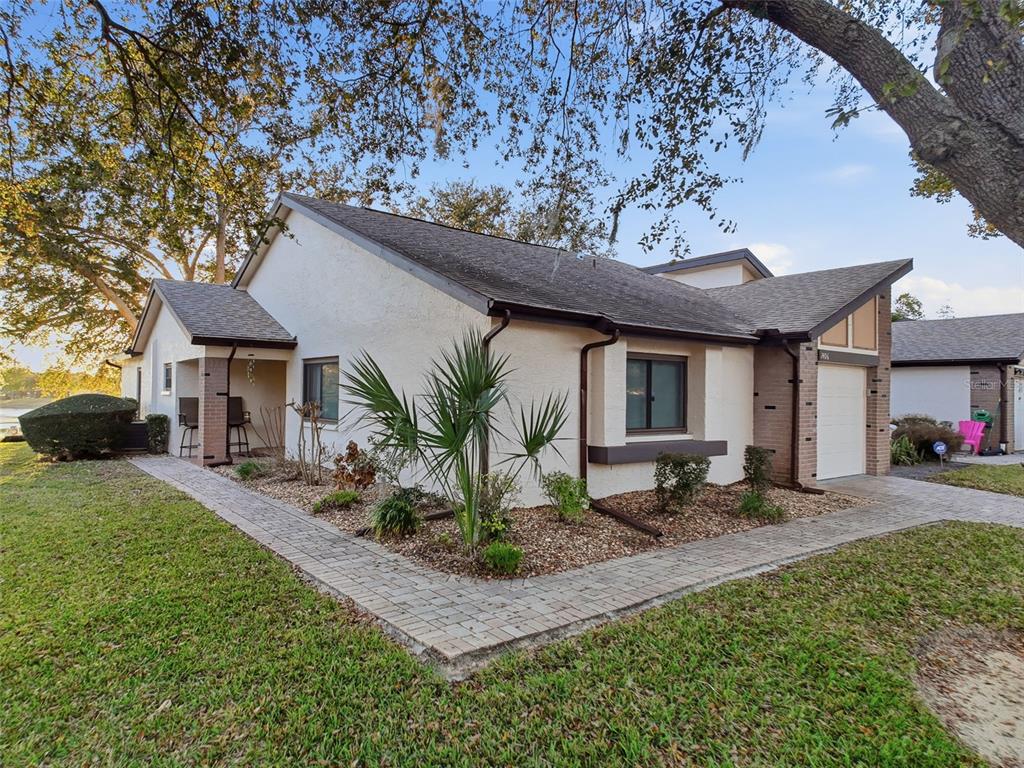 7406 Heather Walk Drive Weeki Wachee, FL 34613 - Photo 13 of 49 a front view of a house with garden