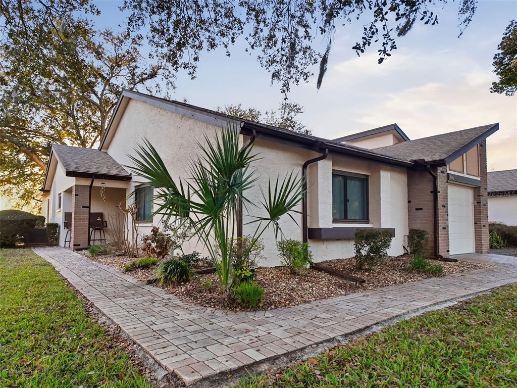 7406 Heather Walk Drive Weeki Wachee, FL 34613 - Photo 15 of 49 a front view of a house with garden and patio
