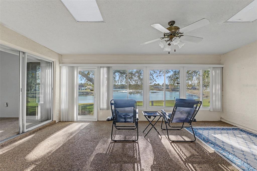 7406 Heather Walk Drive Weeki Wachee, FL 34613 - Photo 3 of 49 a dining room with furniture a chandelier and wooden floor