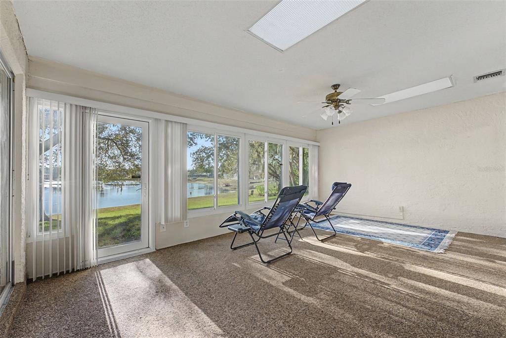 7406 Heather Walk Drive Weeki Wachee, FL 34613 - Photo 39 of 49 a view of a livingroom with lounge chair and windows