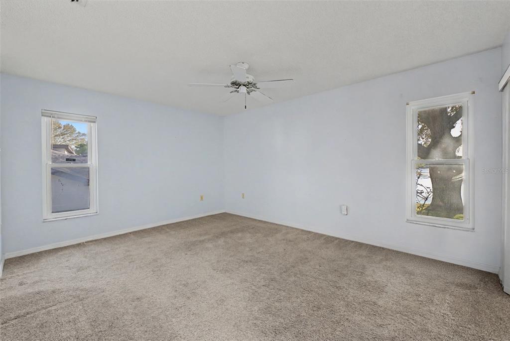 7406 Heather Walk Drive Weeki Wachee, FL 34613 - Photo 43 of 49 an empty room with windows and fan