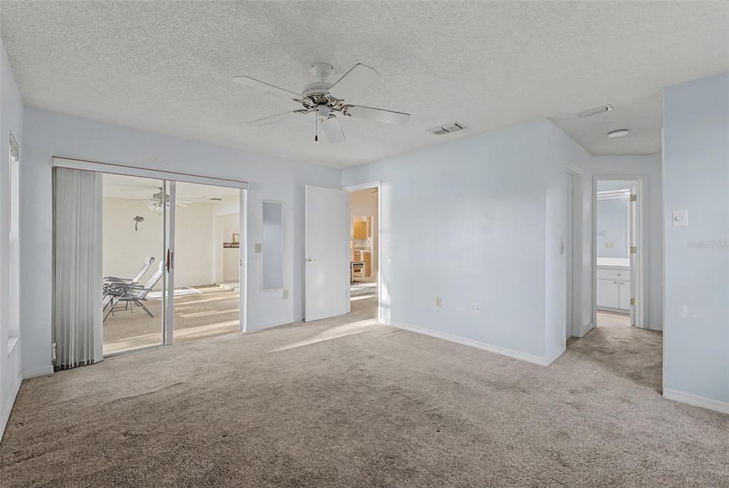7406 Heather Walk Drive Weeki Wachee, FL 34613 - Photo 45 of 49 a view of a livingroom with a chandelier fan and windows