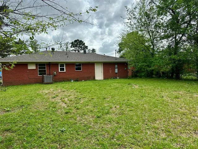 a front view of a house with a garden and yard