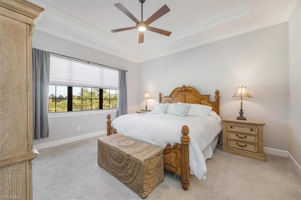 8773 Bellano Court, Unit 201 Naples, FL 34119 - Photo 16 of 34 a bedroom with a bed and a large window