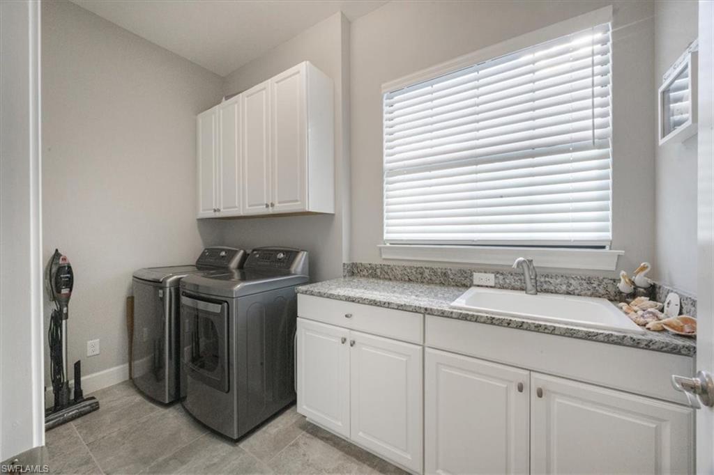 8773 Bellano Court, Unit 201 Naples, FL 34119 - Photo 21 of 34 a view of a kitchen sink and stove