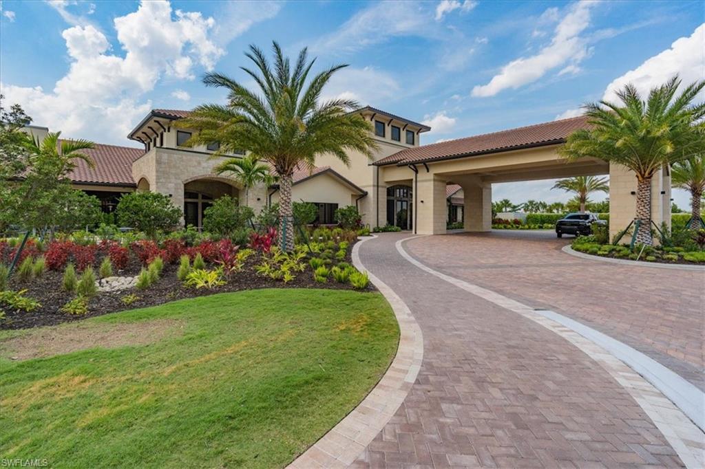 8773 Bellano Court, Unit 201 Naples, FL 34119 - Photo 26 of 34 a front view of house with yard and green space