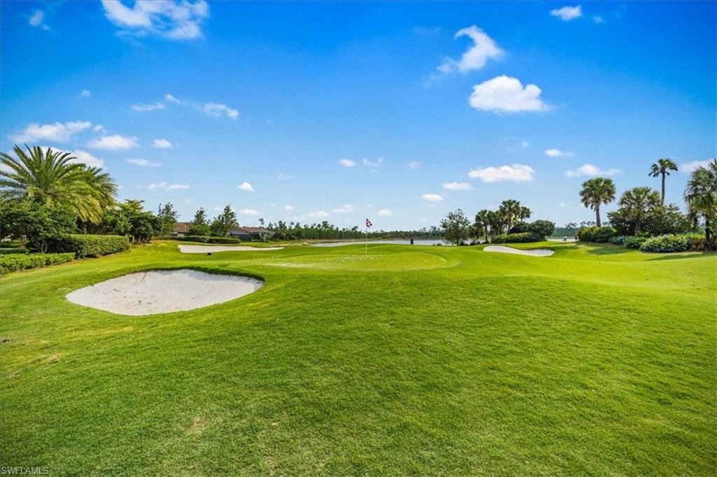 8773 Bellano Court, Unit 201 Naples, FL 34119 - Photo 29 of 34 a view of a swimming pool of a house with a yard