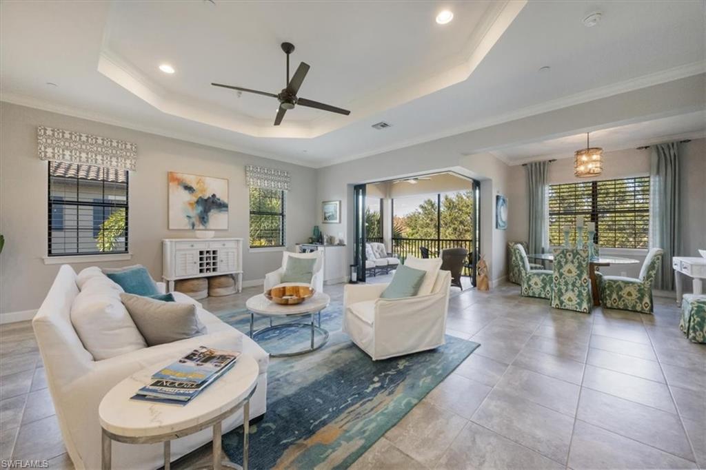8773 Bellano Court, Unit 201 Naples, FL 34119 - Photo 3 of 34 a living room with fireplace furniture and a large window