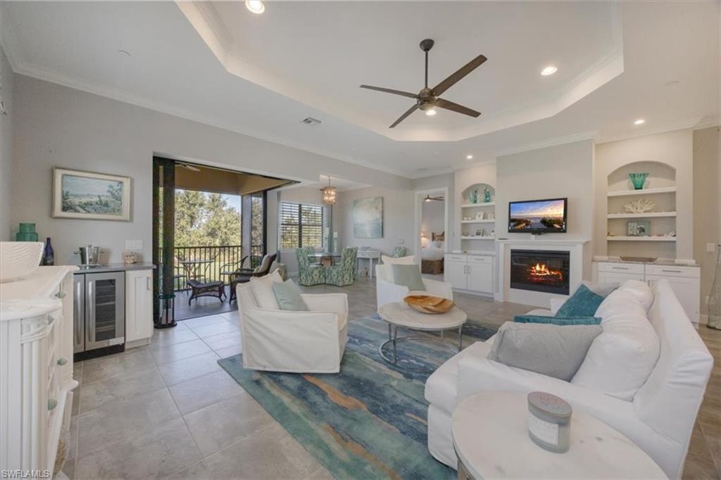 8773 Bellano Court, Unit 201 Naples, FL 34119 - Photo 5 of 34 a living room with furniture and a fireplace