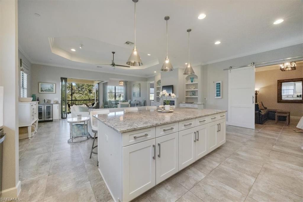 8773 Bellano Court, Unit 201 Naples, FL 34119 - Photo 10 of 34 a bathroom with a granite countertop sink and a large mirror