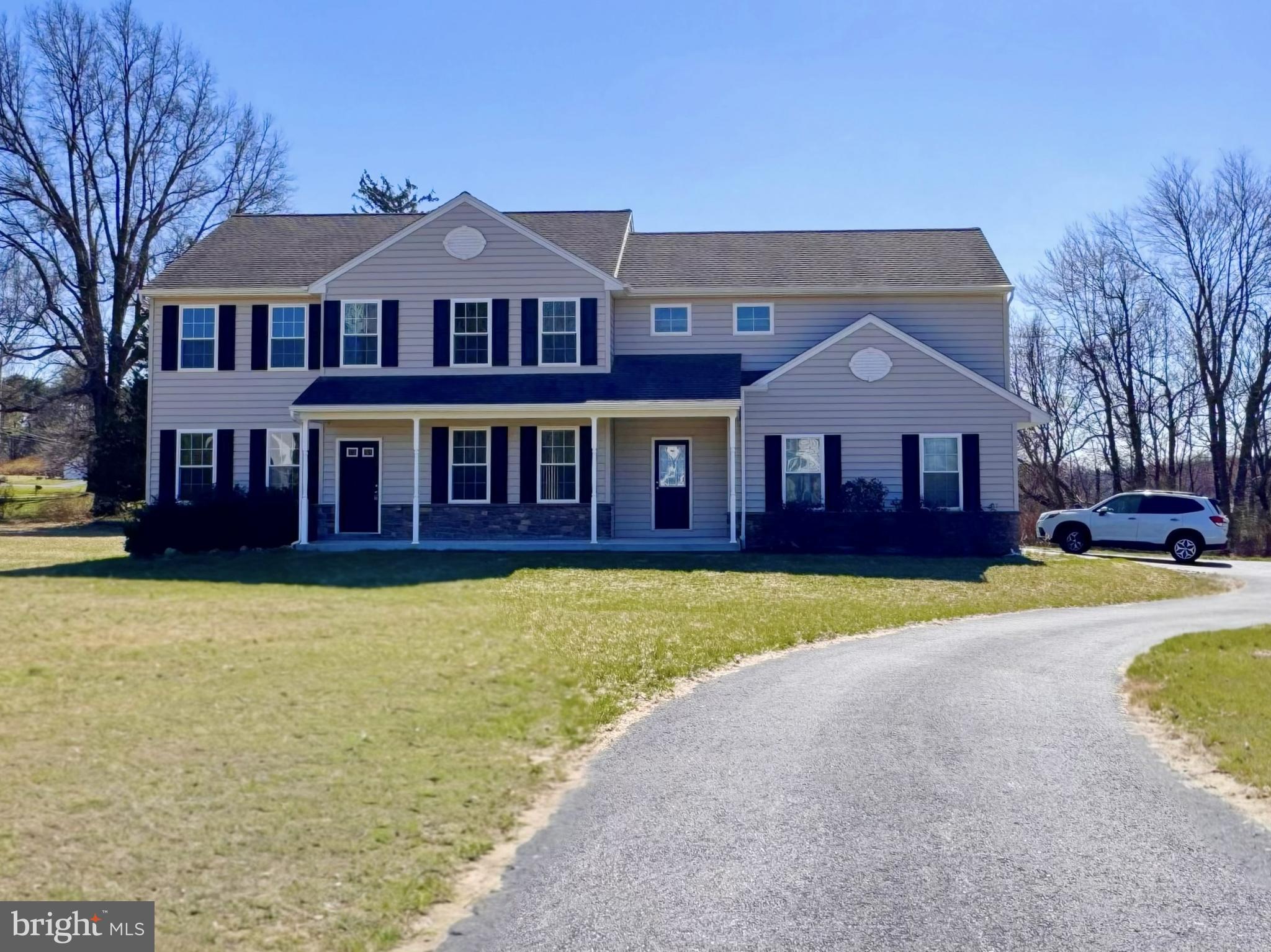 a front view of a house with a yard and swimming pool
