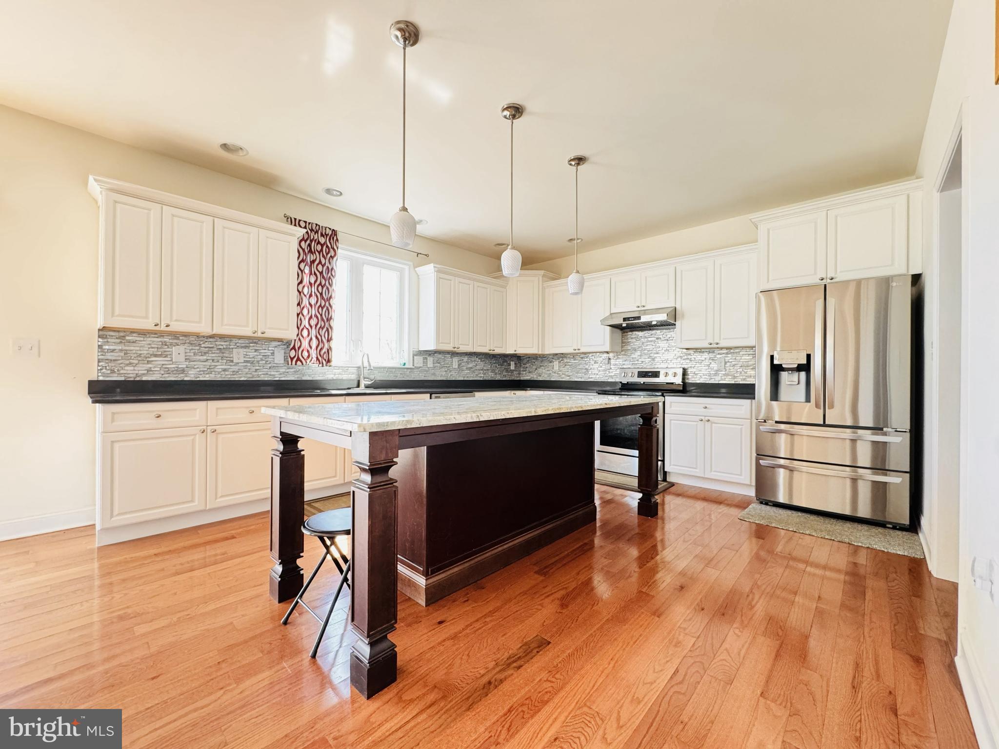20 Lippitt Road Honey Brook, PA 19344 - Photo 11 of 38 a kitchen with stainless steel appliances granite countertop a refrigerator a stove a sink and white cabinets with wooden floor