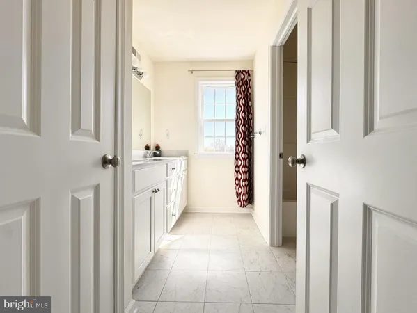 a bathroom with a sink a mirror and a shower