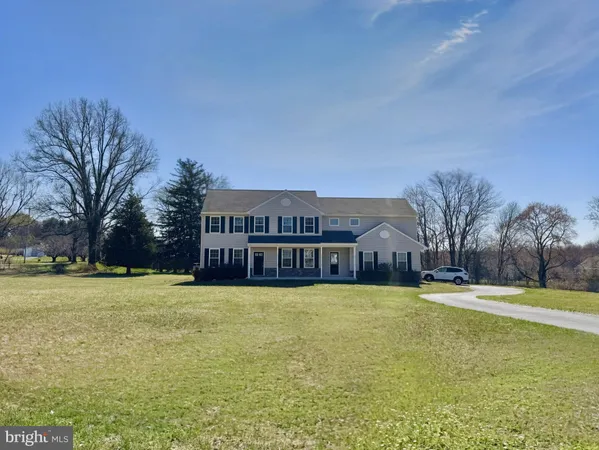 a view of a large pool with a house in the background