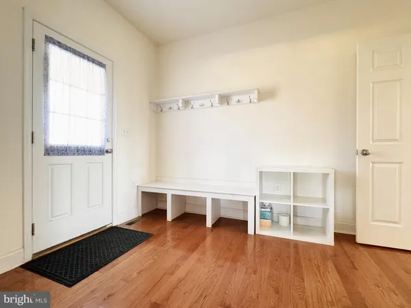 a view of a room with wooden floor and cabinet