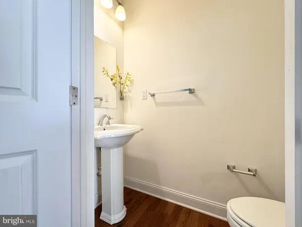 a bathroom with a sink mirror and toilet
