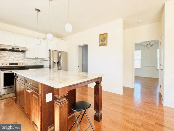 a kitchen with a counter space a sink and cabinets