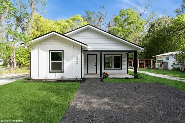 a front view of house with a garden