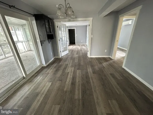 a view of a hallway view with wooden floor and staircase
