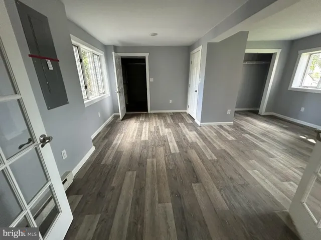 wooden floor in an empty room with a fireplace