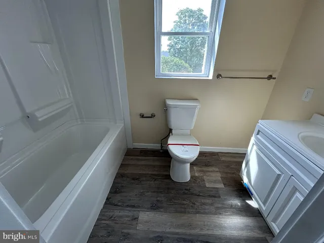 a bathroom with a toilet and a bathtub