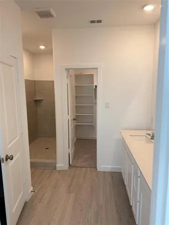 a bathroom with a double vanity sink and shower