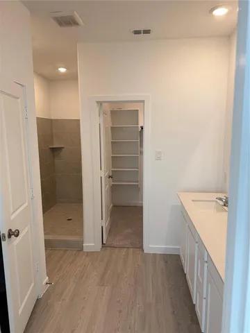 a bathroom with a double vanity sink and shower