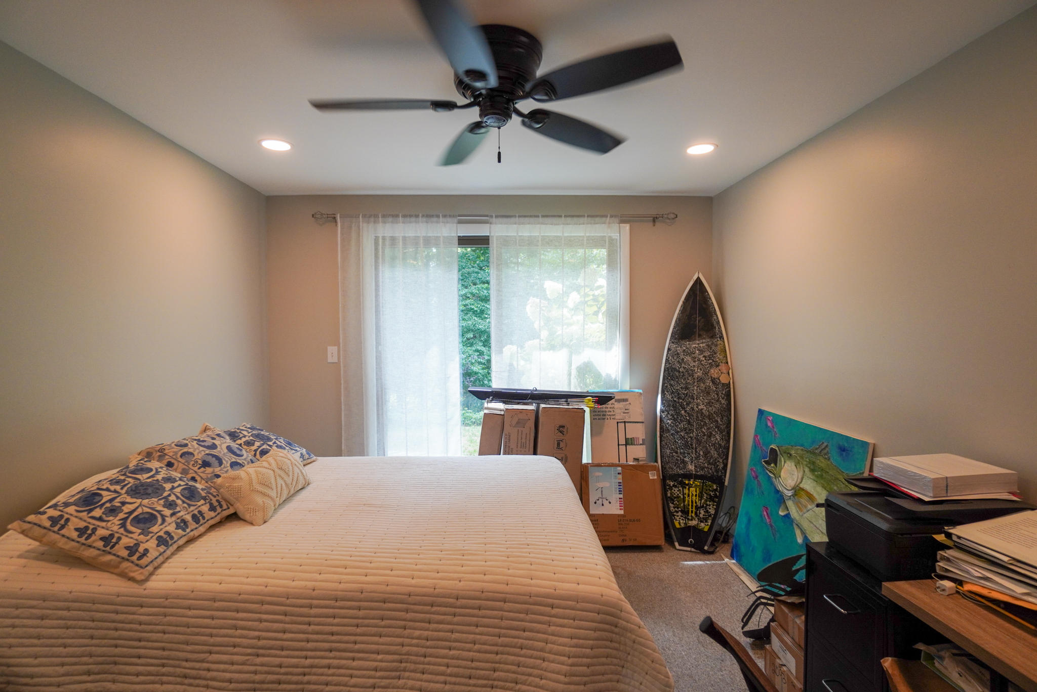 92 Springhill Road Vineyard Haven, MA 02568 - Photo 26 of 38 a bedroom with a bed a desk and a chandelier