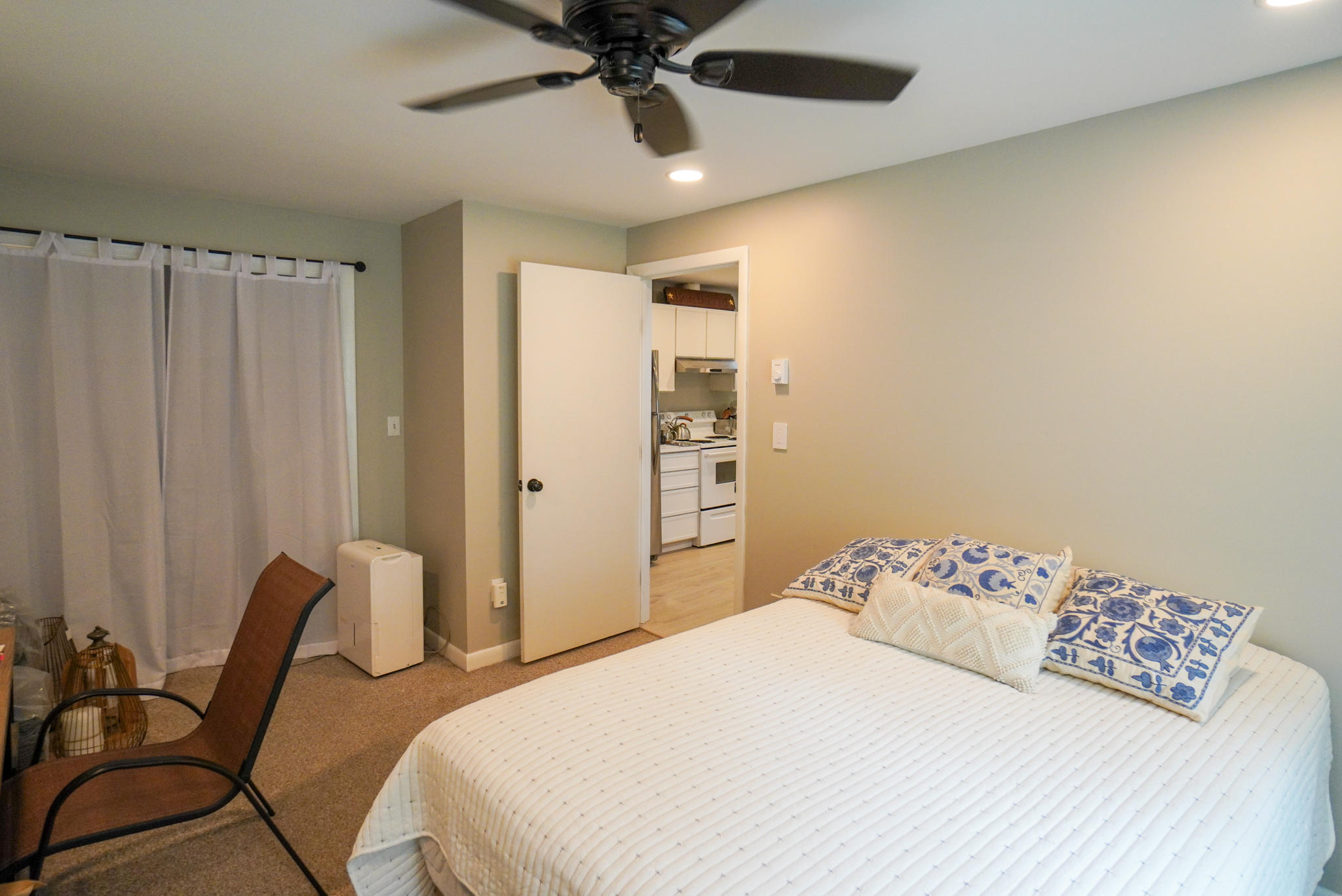 92 Springhill Road Vineyard Haven, MA 02568 - Photo 29 of 38 a bedroom with a bed and a chandelier