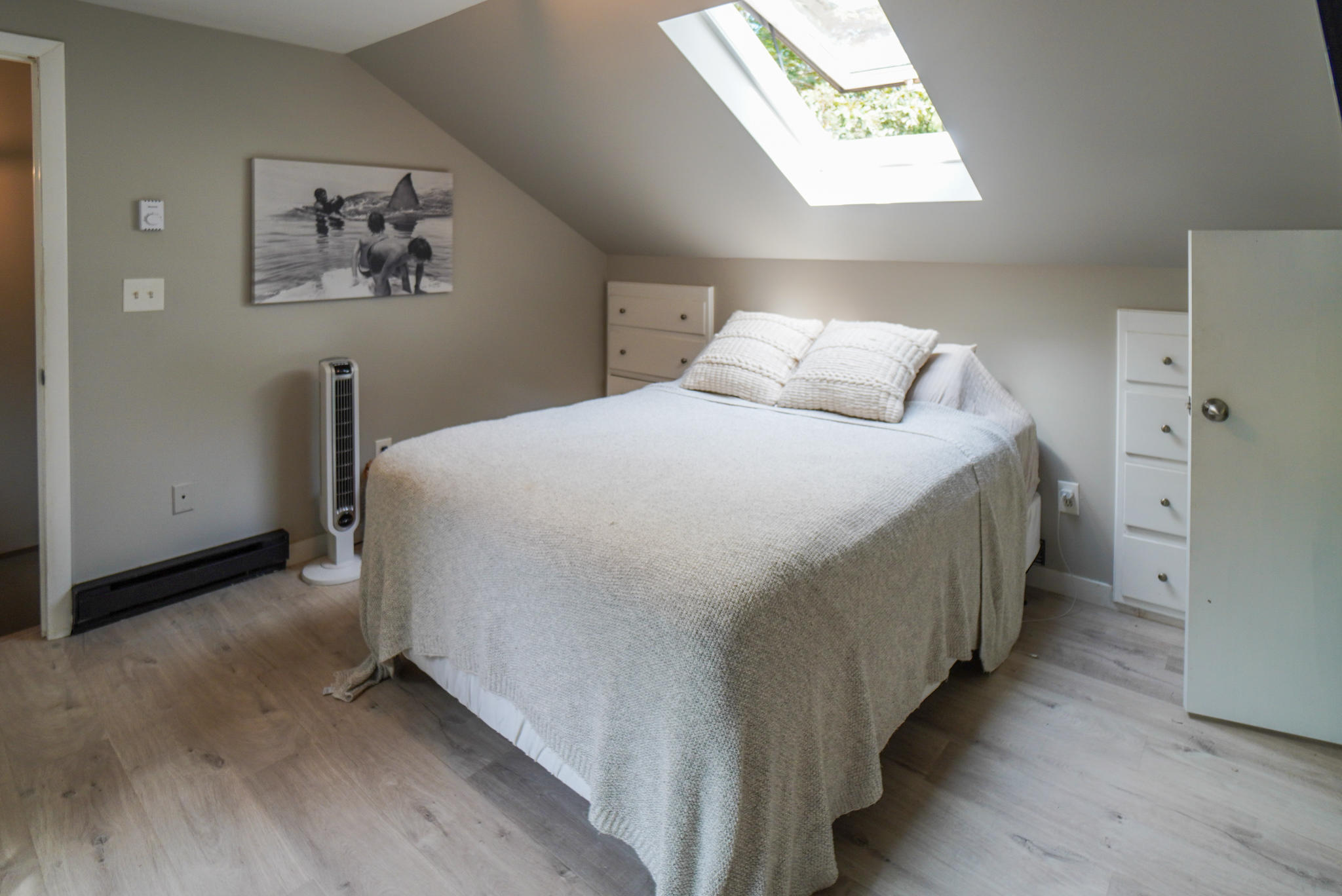92 Springhill Road Vineyard Haven, MA 02568 - Photo 35 of 38 a spacious bedroom with a bed and a painting on the wall